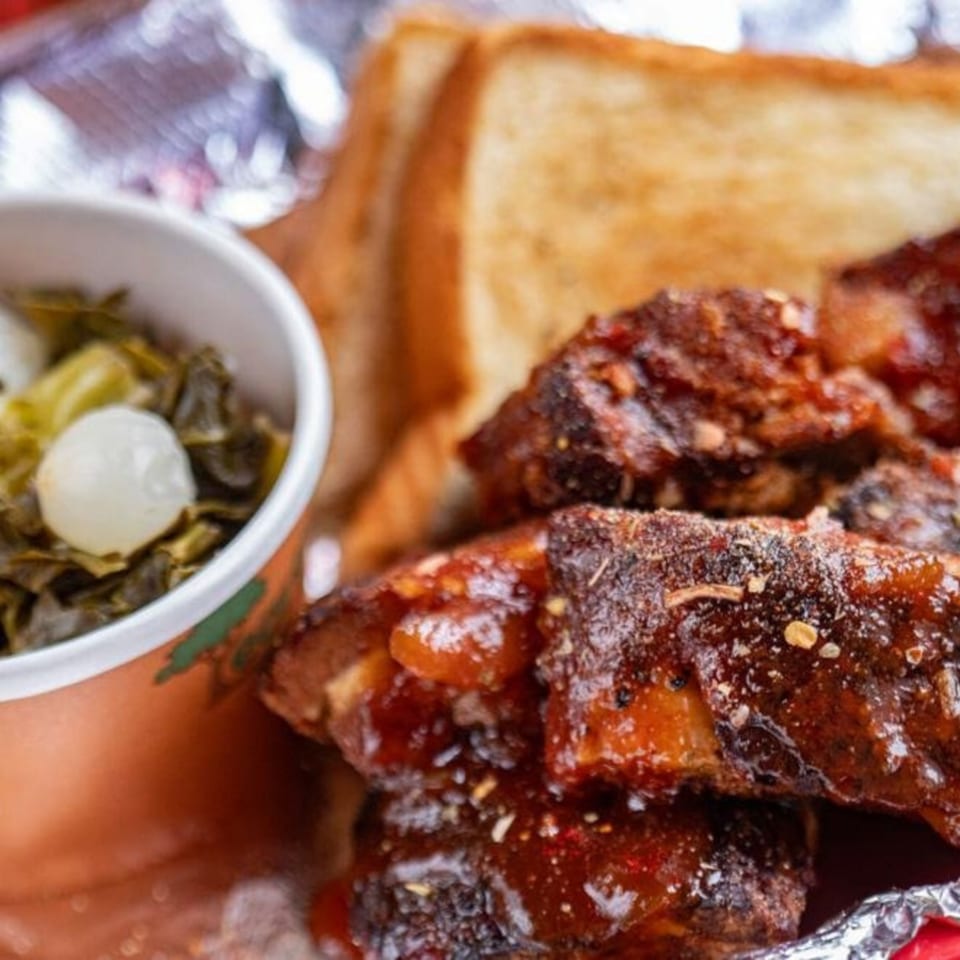 Five Ace's Smokestaq Lightning BBQ ribs with collard greens and toasted bread.